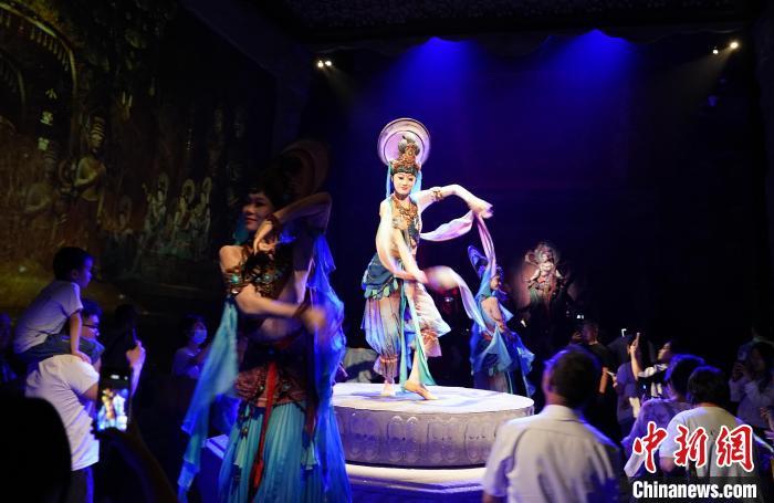 《樂動敦煌》是全球首部洞窟式沉浸體驗劇，利用真人與數(shù)字影像虛實交換實現(xiàn)沉浸式體驗。圖為2023年8月28日晚，《樂動敦煌》演出。(資料圖)中新社記者 毛建軍 攝